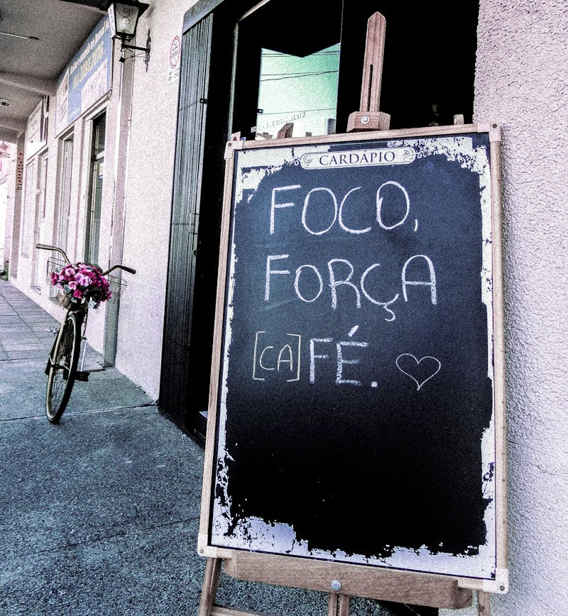 A-frame chalkboard sign outside a cafe entrance attracting foot traffic