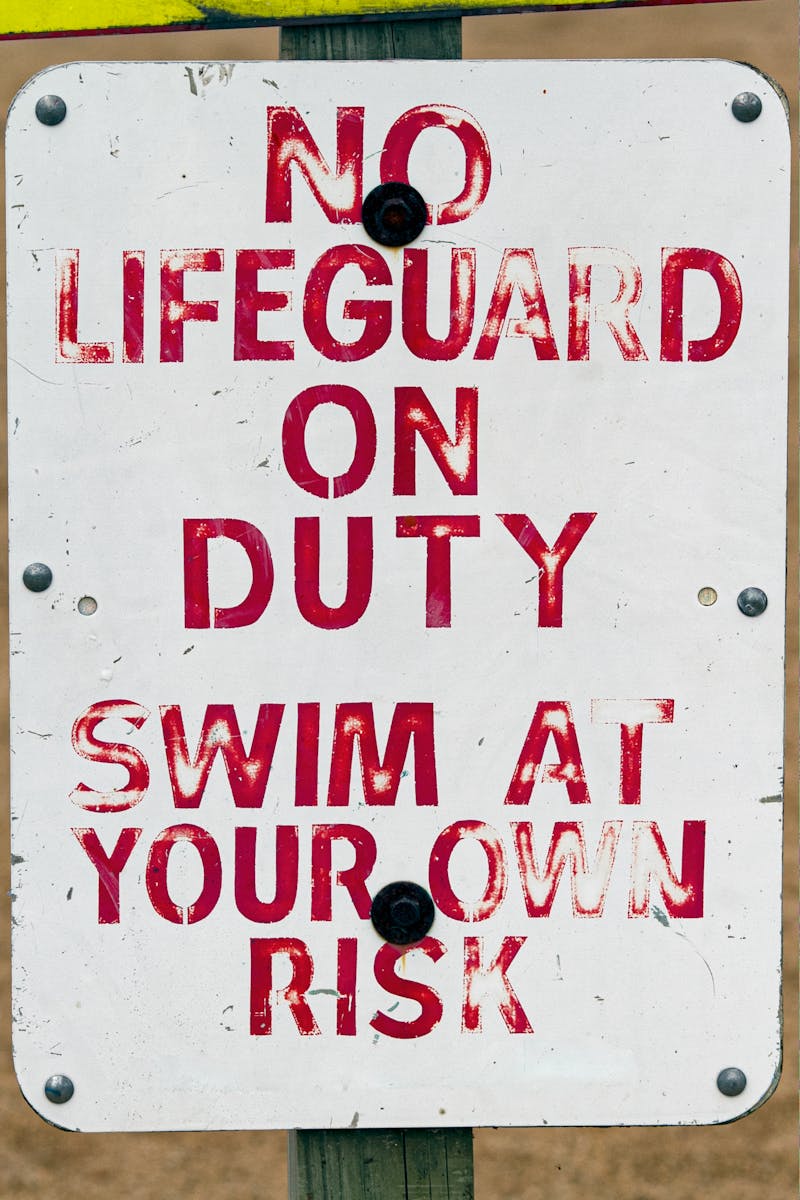 Warning sign indicating no lifeguard on duty swim at your own risk