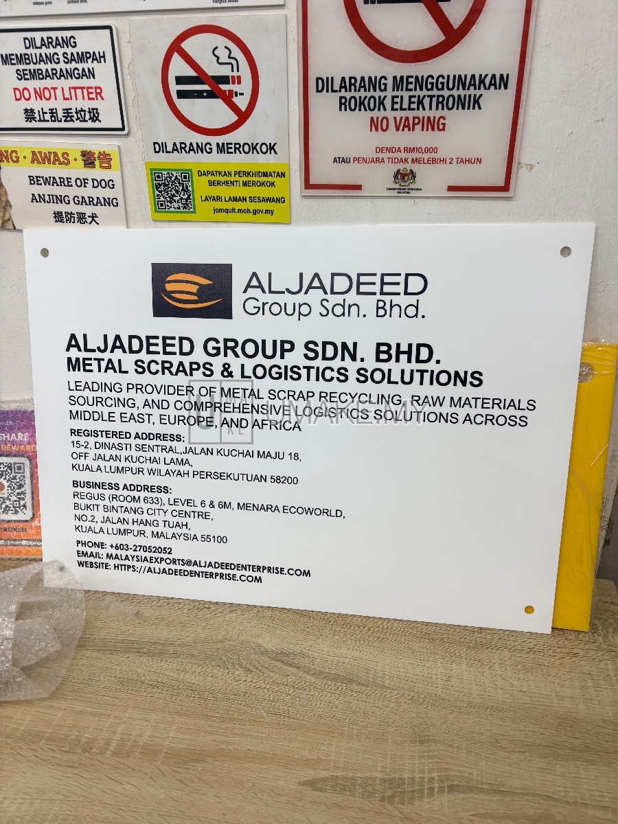 Clear acrylic signage with vibrant UV direct print, showcasing a Malaysian company logo and text, edge-lit for high visibility and professional finish