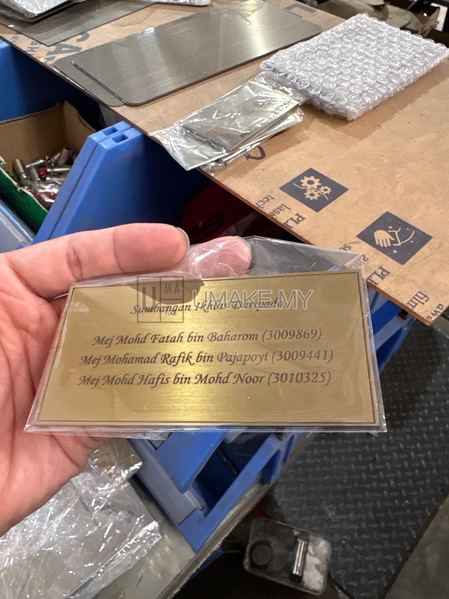 A gold-finished stainless steel nametag with precision laser engraving, showcasing durable and elegant labeling for industrial or corporate use.