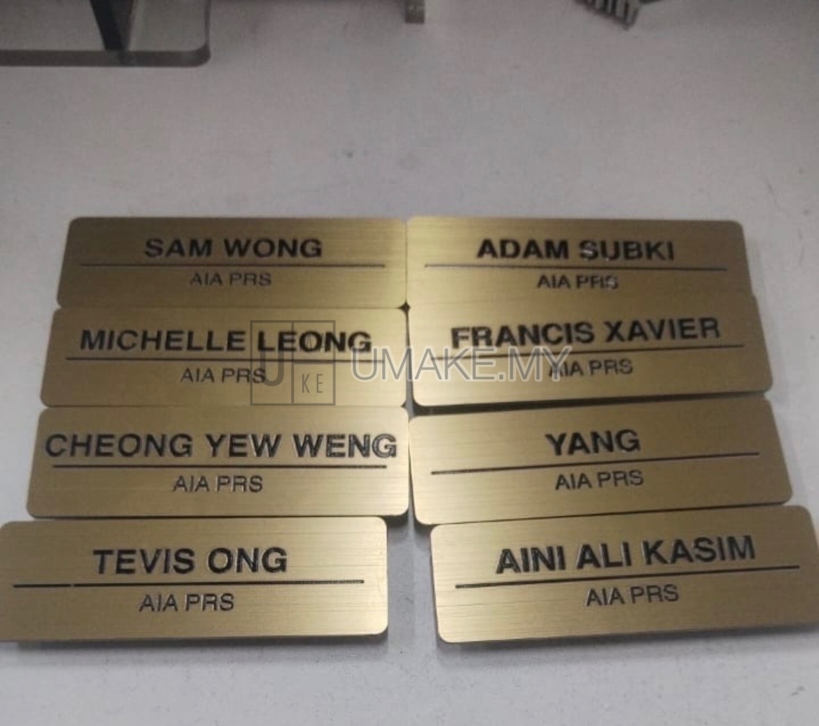 A stainless steel gold nametag with perfectly printed black text, showcasing high-precision direct printing for professional identification.