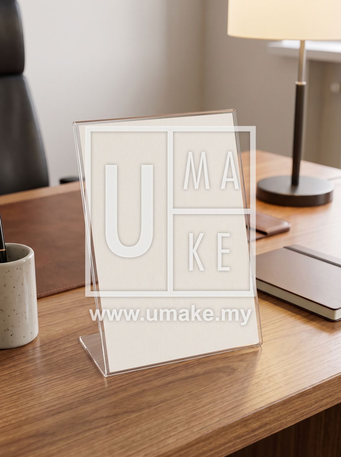 Blank card in a clear acrylic slanted display stand on an office desk
