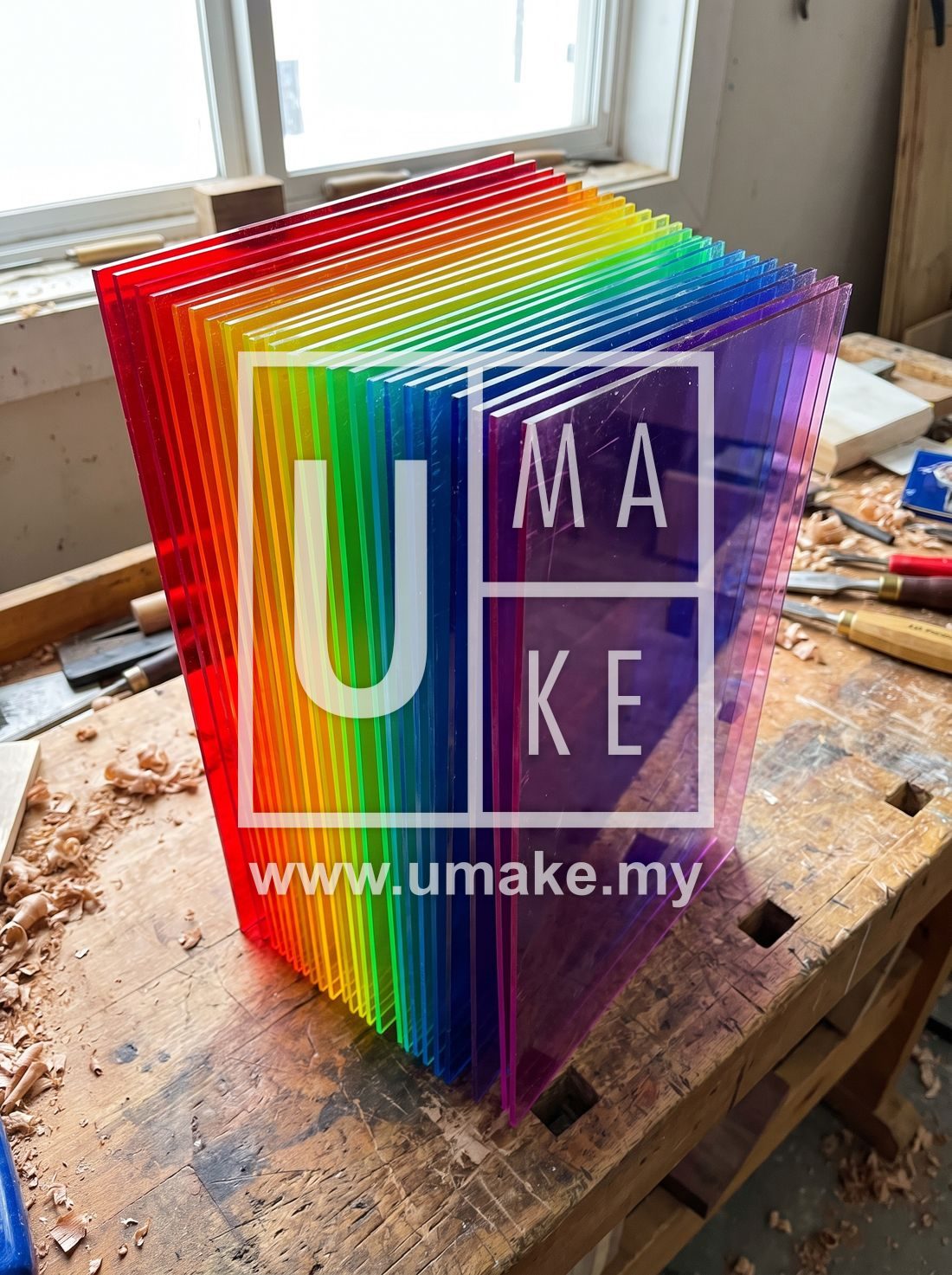 Fanned stack of coloured acrylic sheets in rainbow colours
