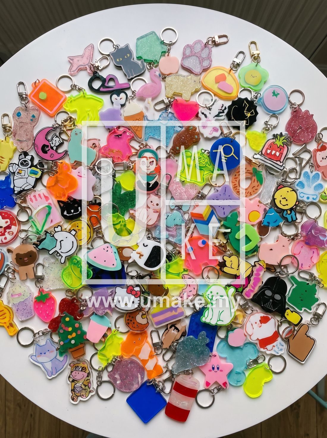 Flat lay of colourful custom acrylic keychains in many shapes and designs