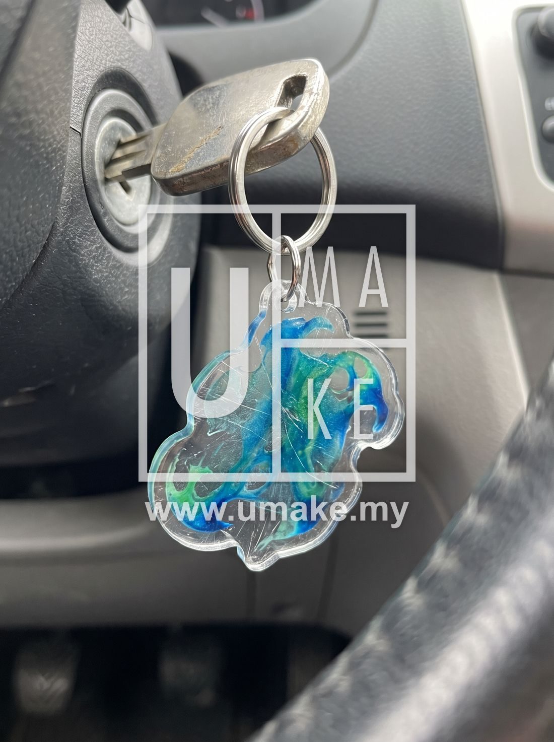 Custom acrylic keychain hanging from a car ignition key