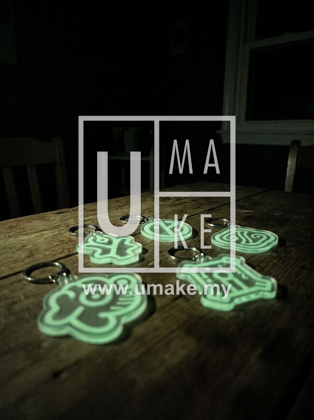 Glow-in-the-dark acrylic name keychains glowing green in the dark