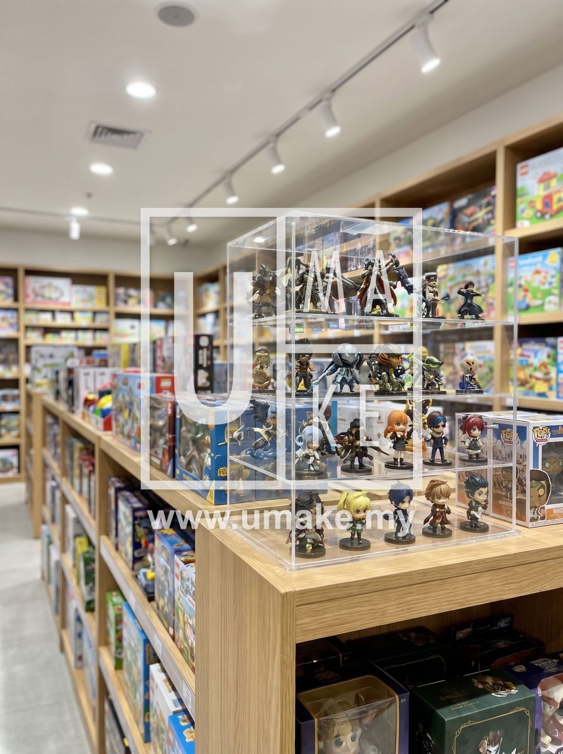Clear acrylic display case holding collectible figures in a retail store