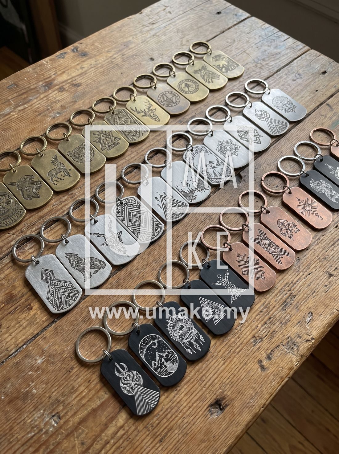 A collection of laser-engraved metal keychains arranged neatly on a table