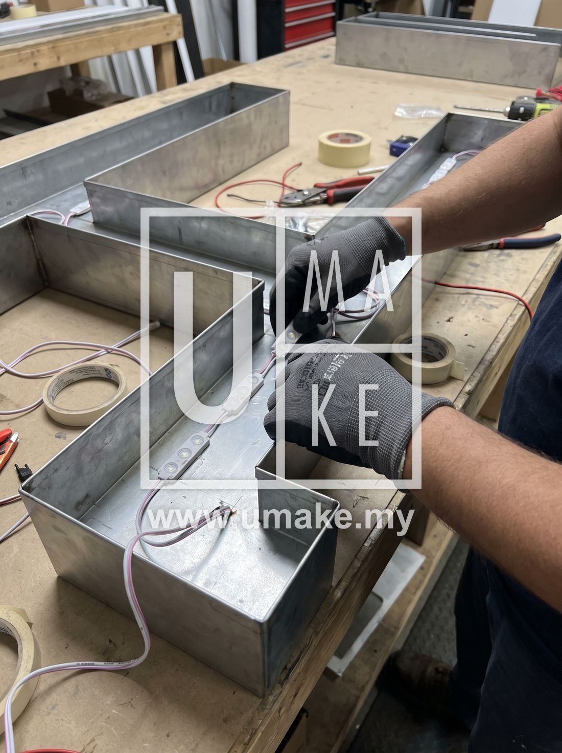 Close-up of LED modules being installed inside a metal box-up letter