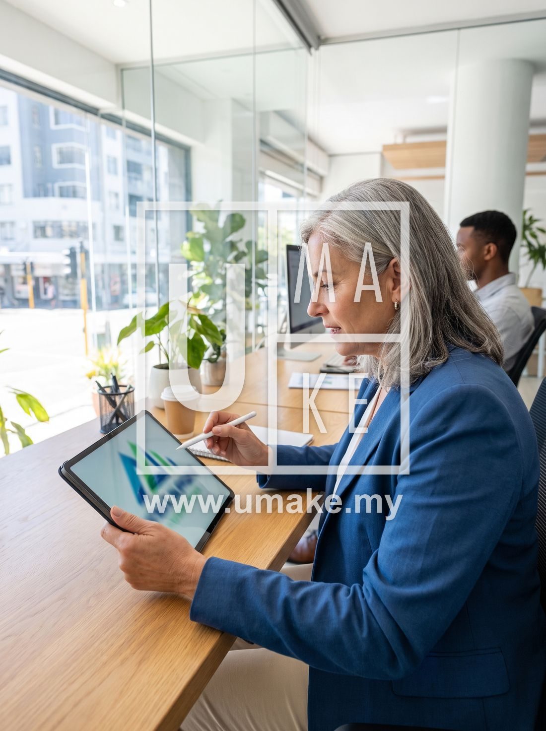 A business owner reviewing a signage design proposal on a tablet in a modern office