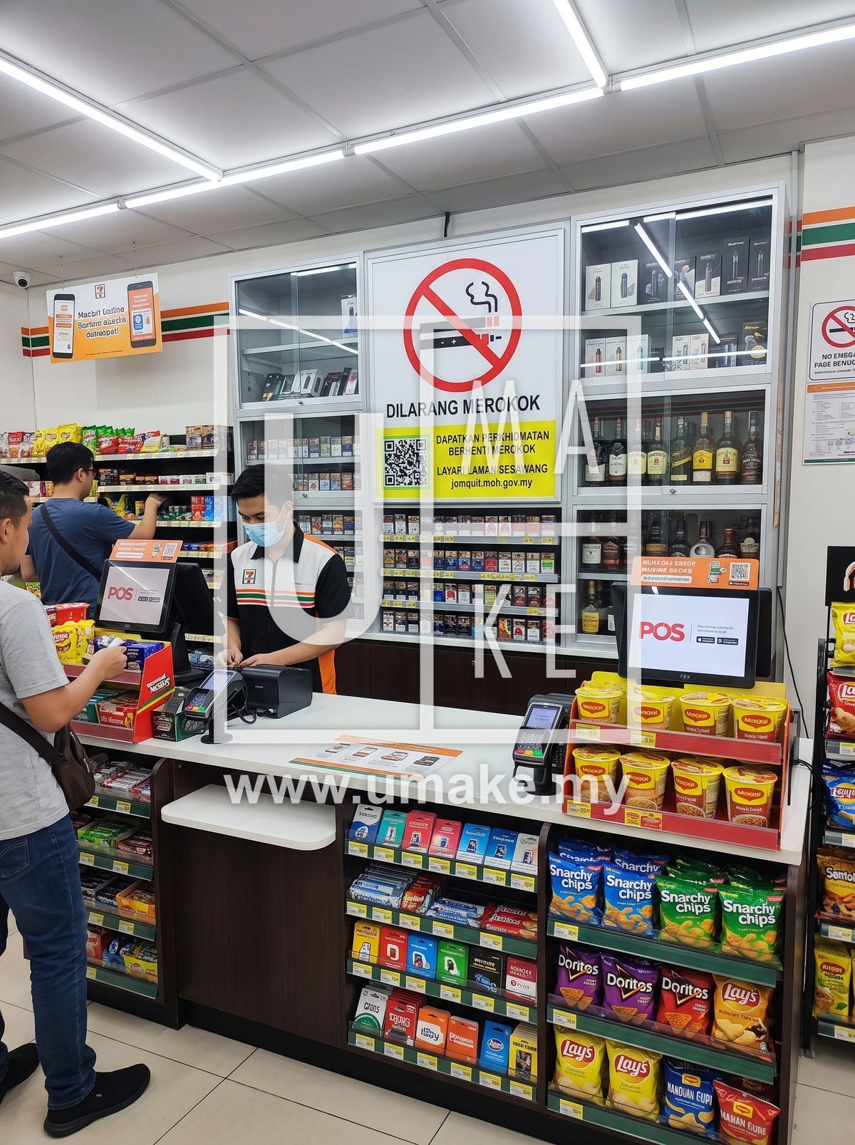 KKM no smoking and tobacco sales warning sign behind a Malaysian convenience store counter