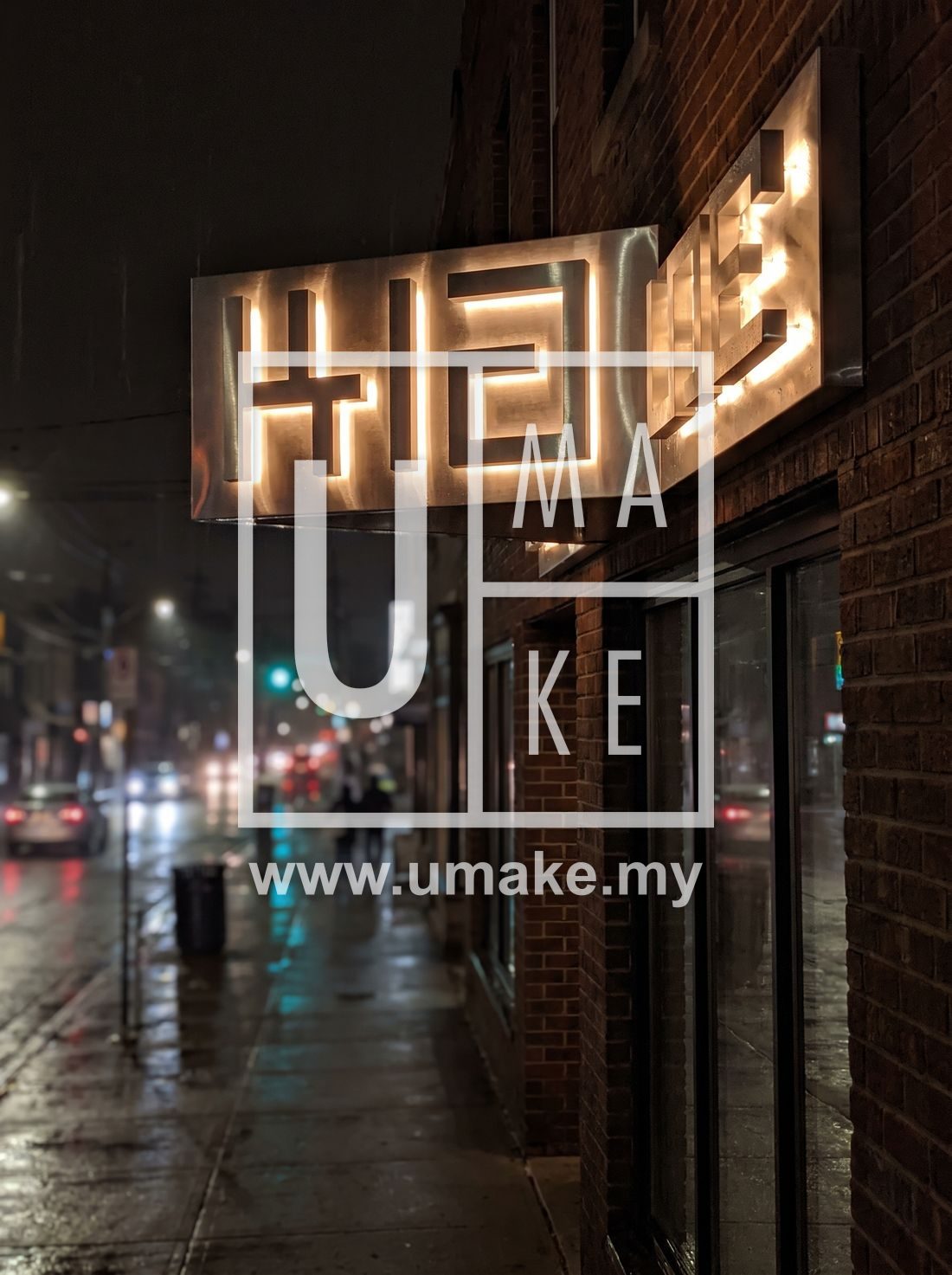 A glowing 3D box-up channel letter shopfront sign at night