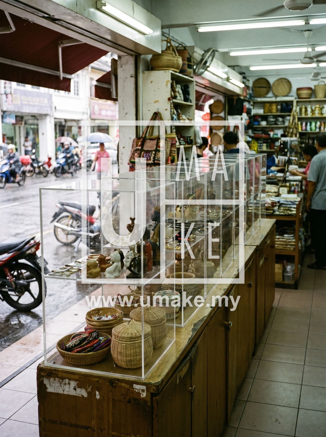 A row of clear acrylic display cases in a Malaysian shop