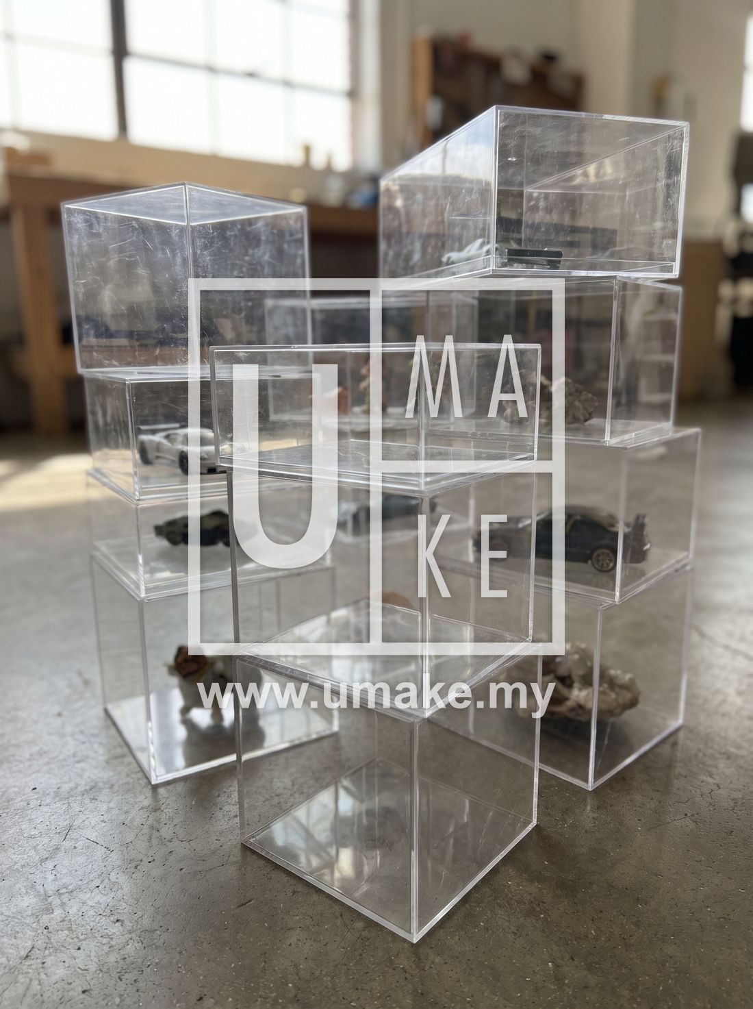 A stack of custom acrylic display cases in various sizes