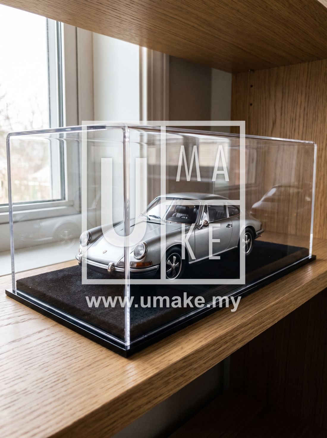 A clear acrylic display case holding a model car