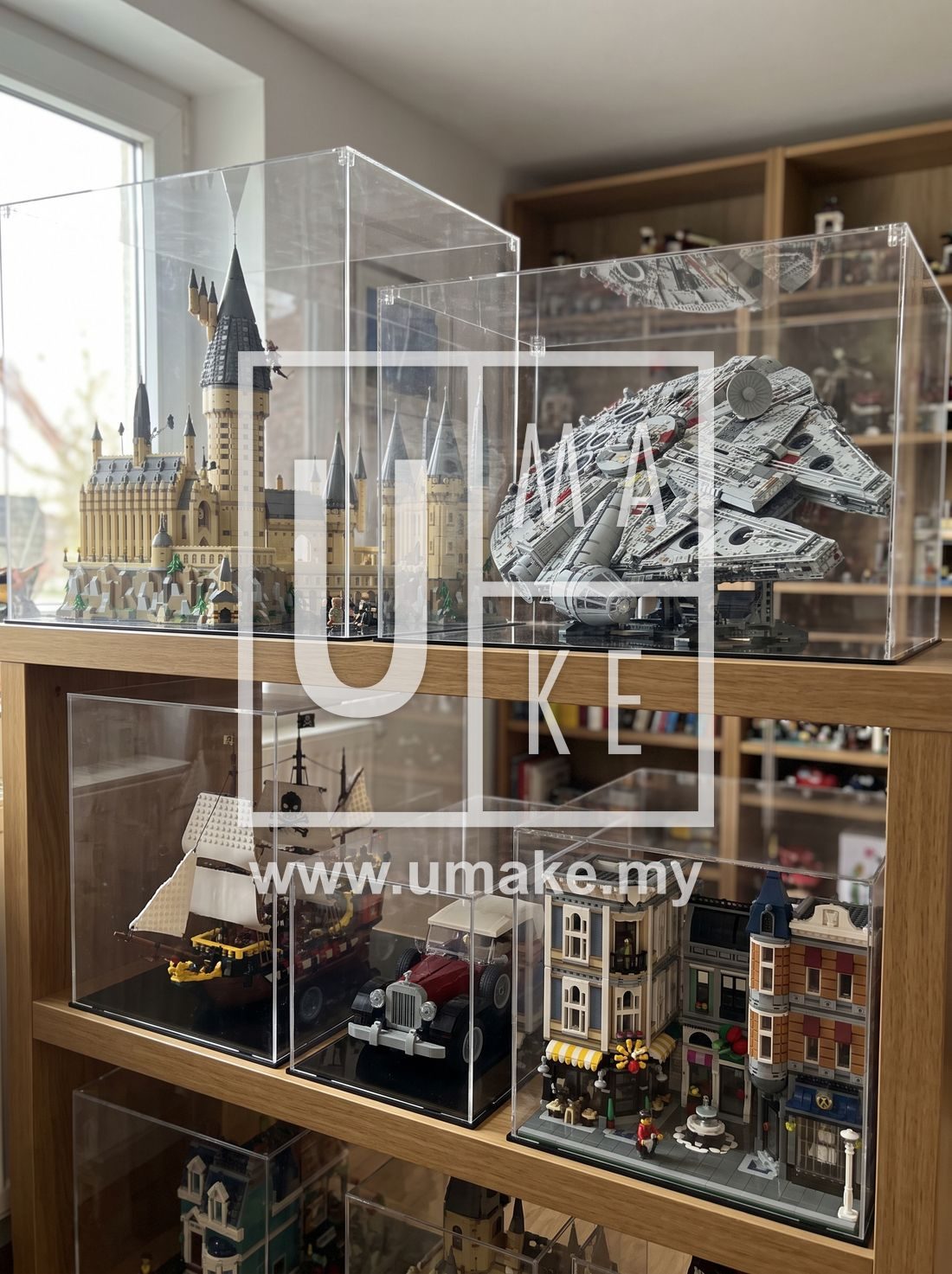 A shelf of Lego sets in clear acrylic display boxes