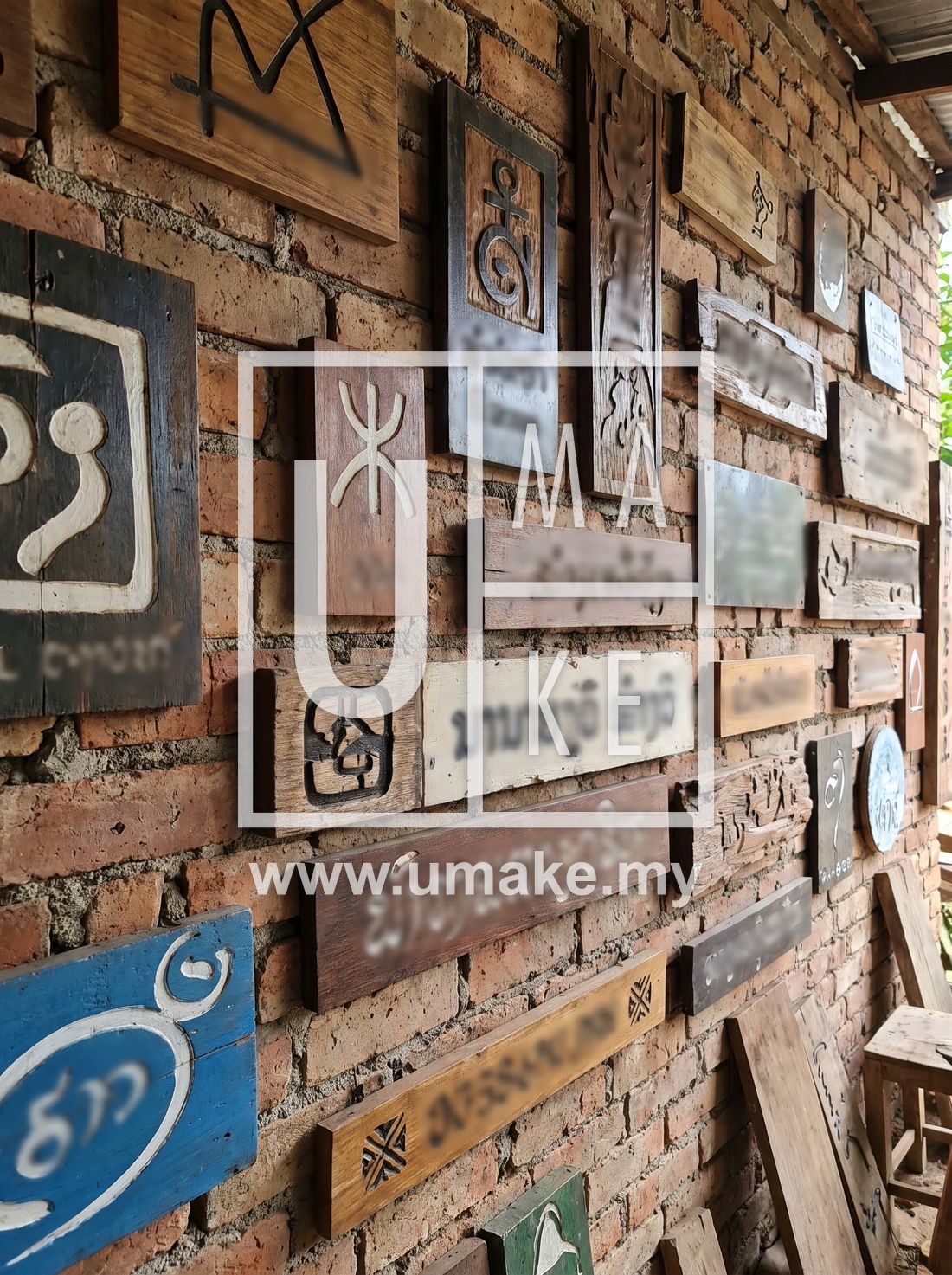 A portfolio of finished signboards on a wall