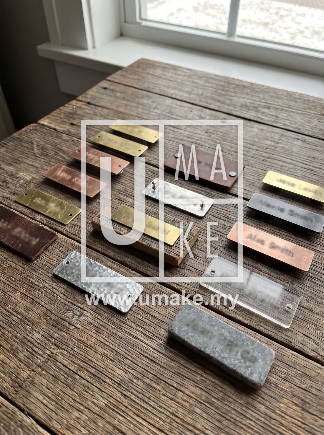 A set of custom name tags in different materials on a table