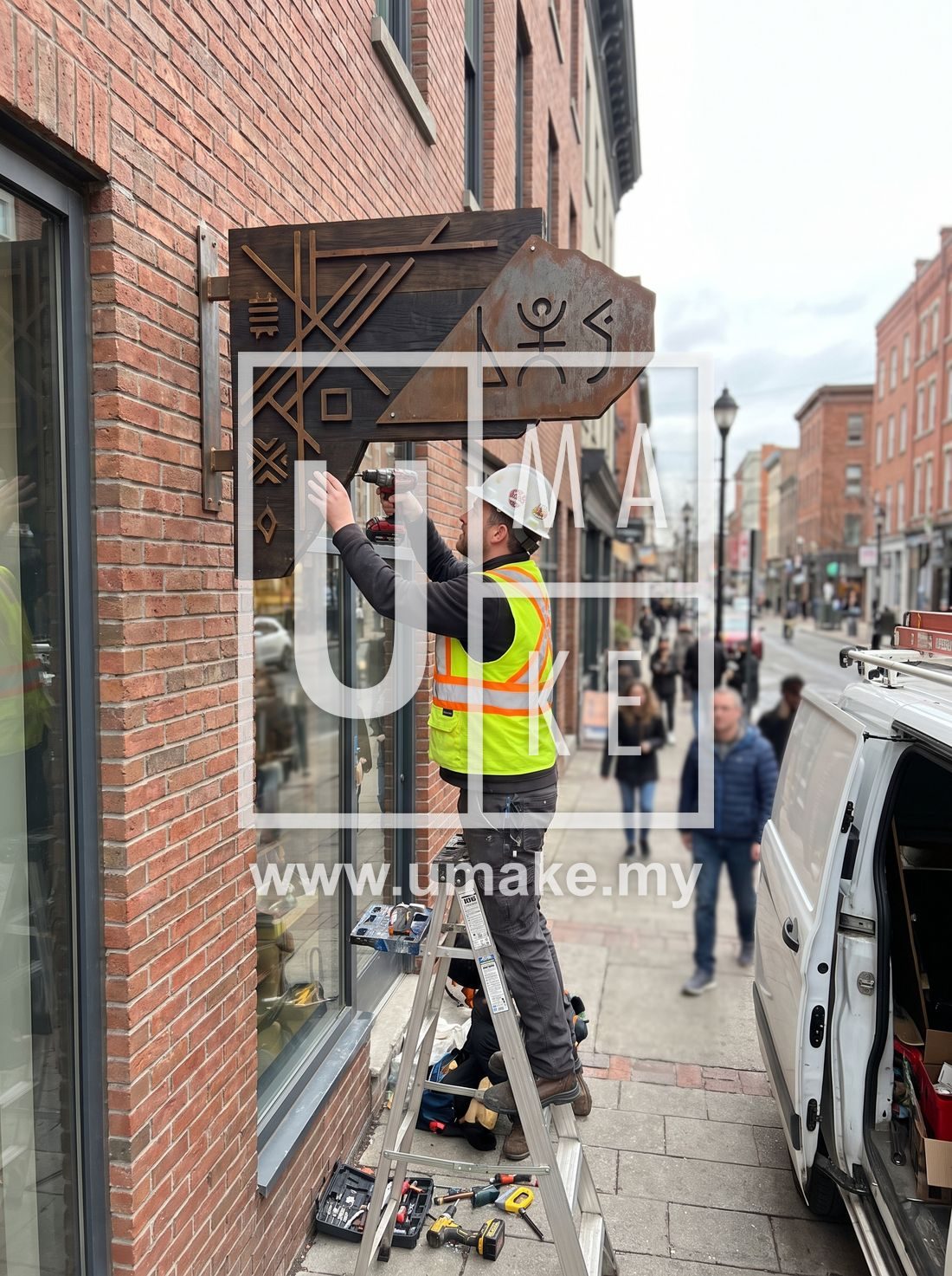 A signage installer mounting a custom sign on a shop