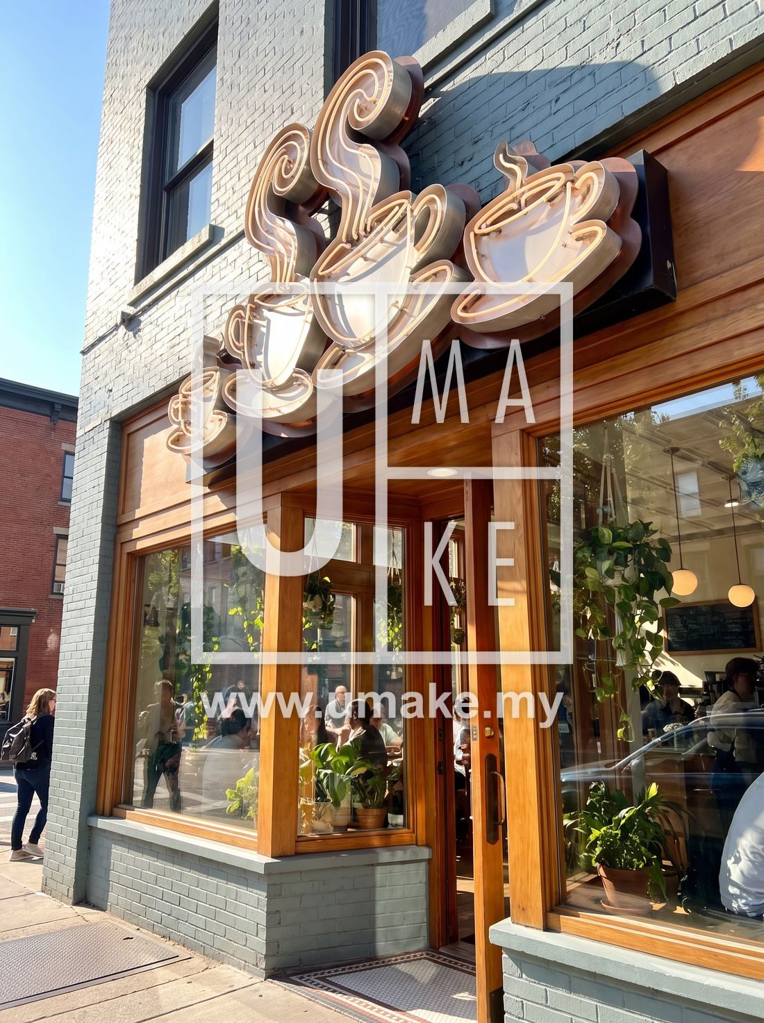 A bright cafe storefront with a custom illuminated sign