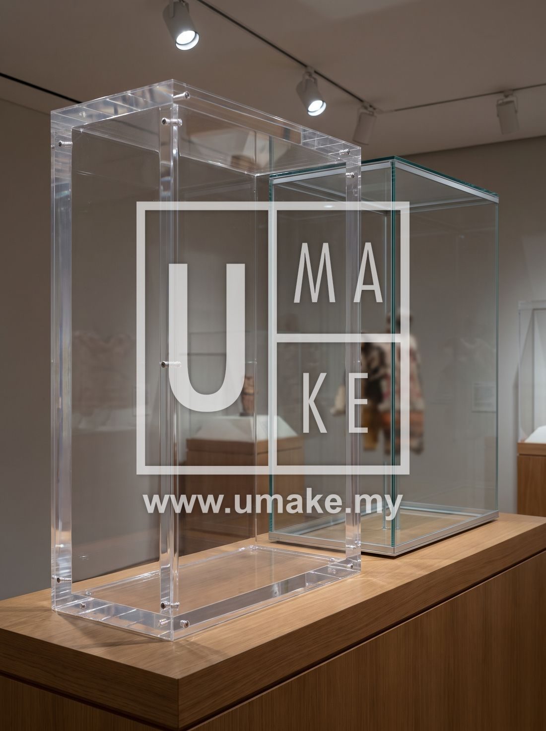 A sturdy clear acrylic display case beside a glass one