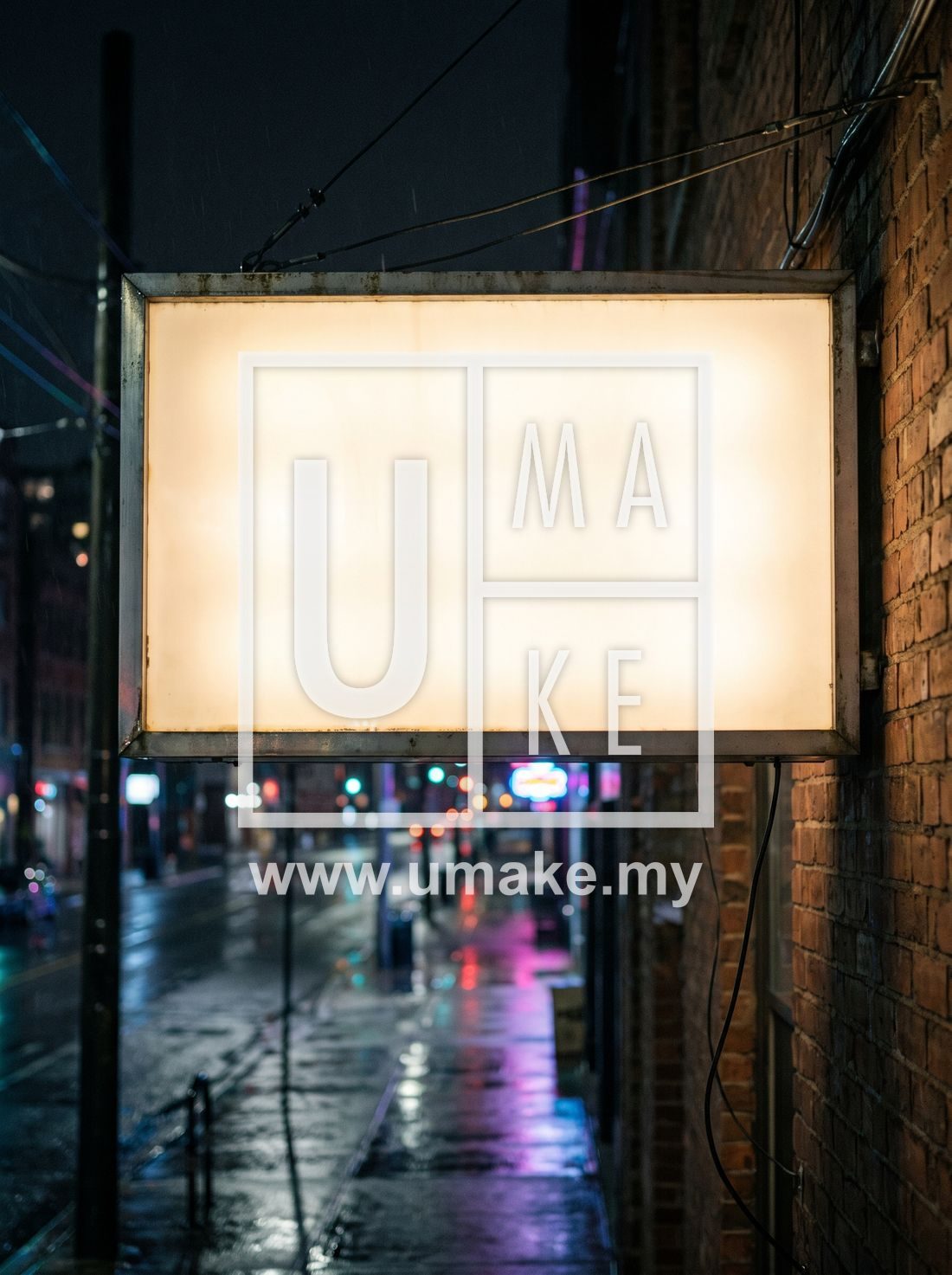 An illuminated lightbox signboard glowing at night