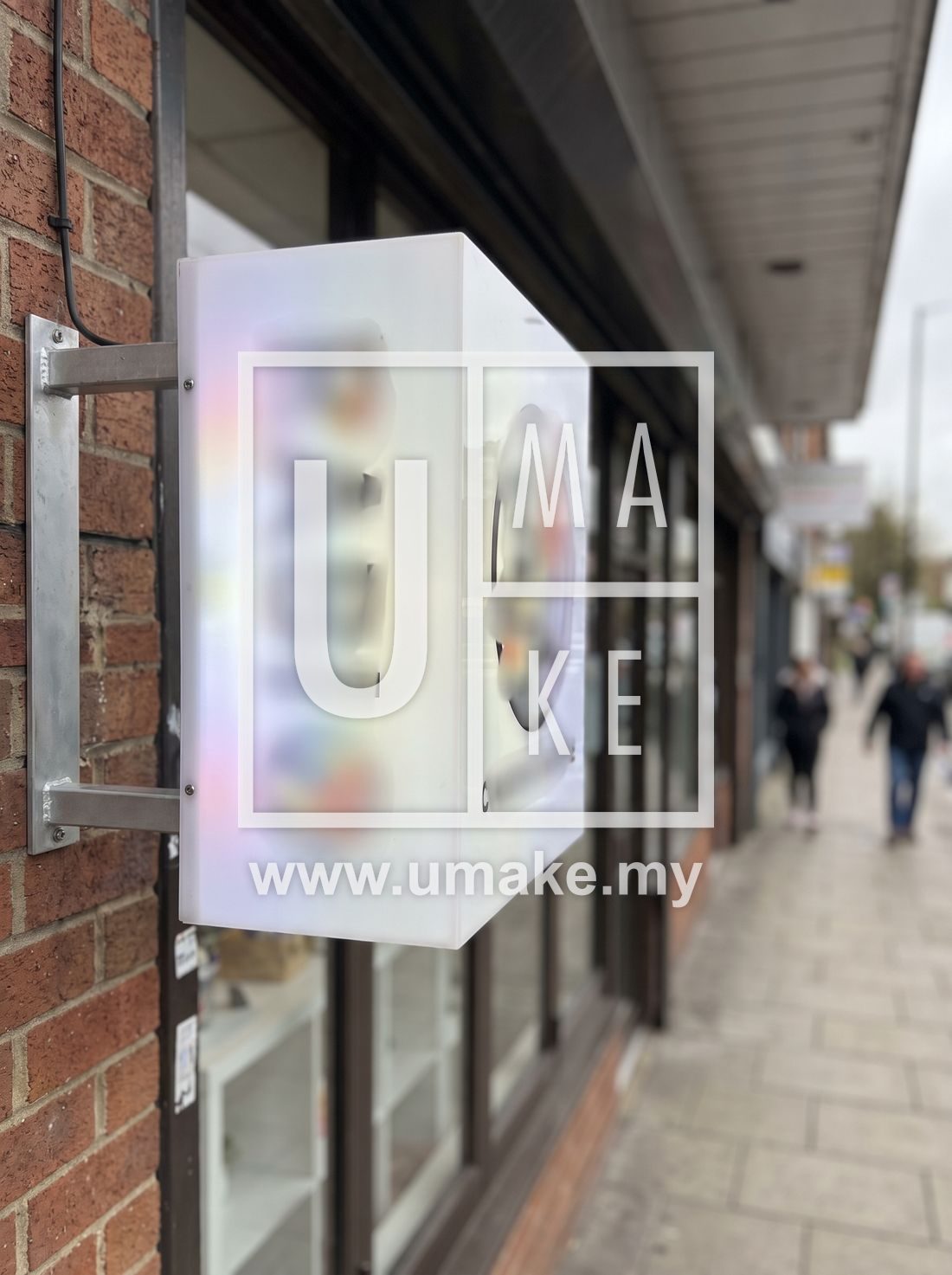A bright double-sided lightbox sign outside a shop