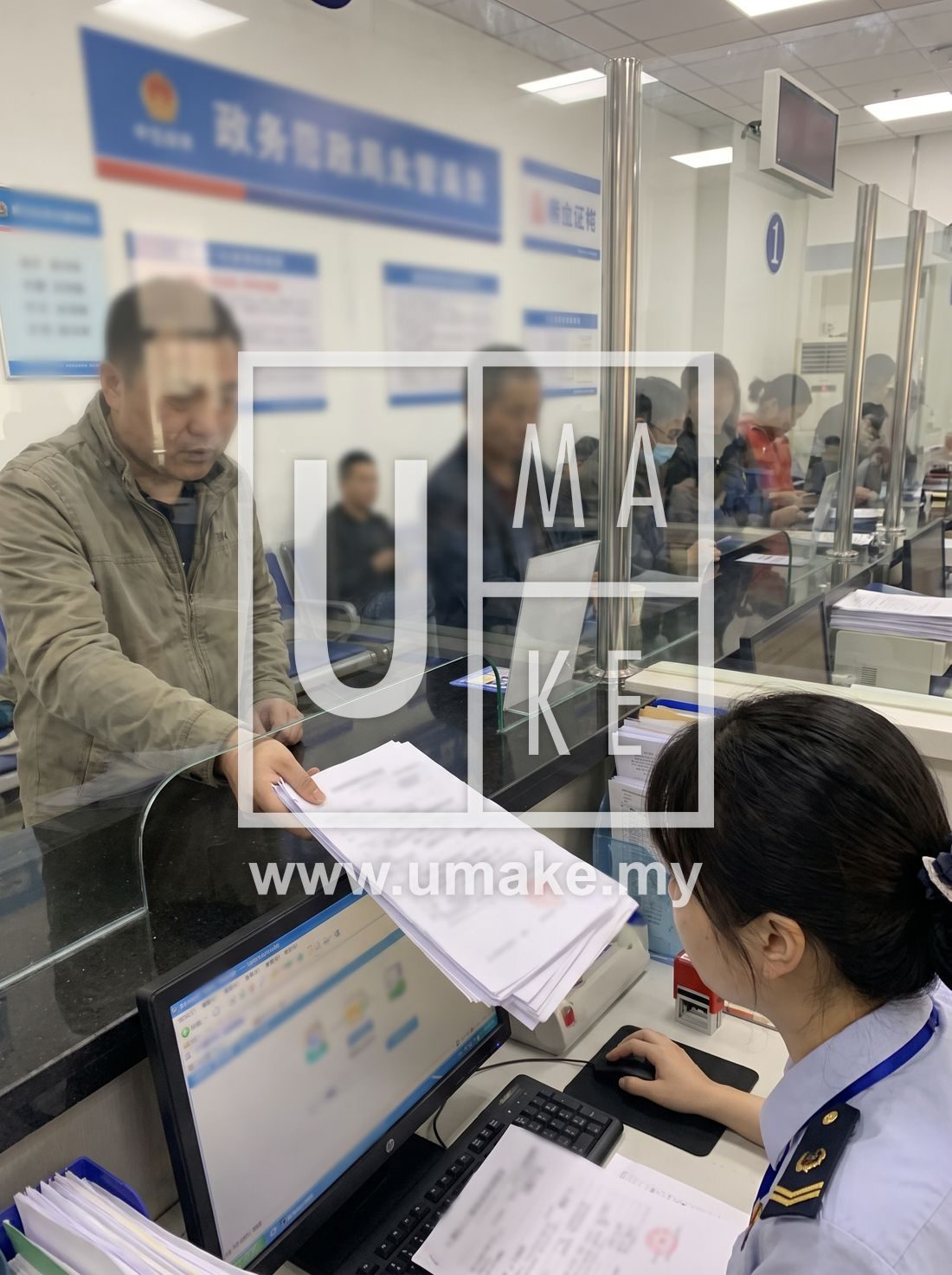 A business licence application being processed at a counter