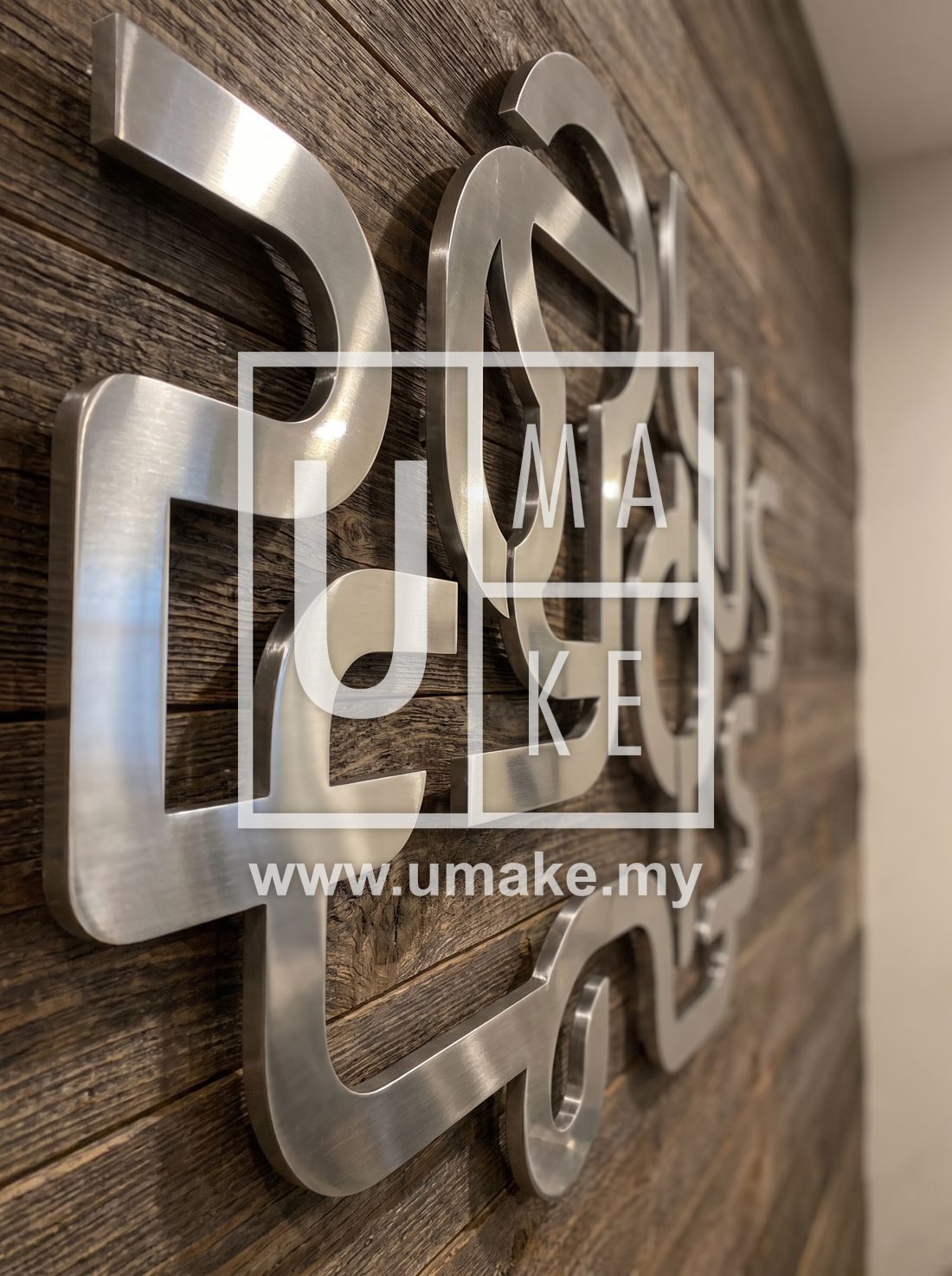 Close-up of polished 3D metal letters on a feature wall