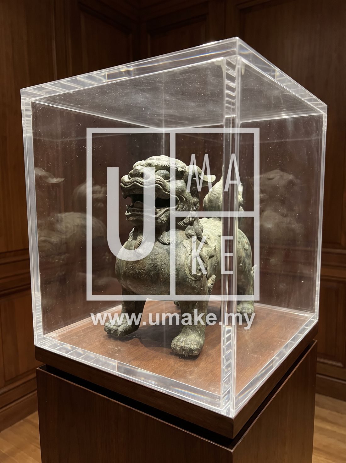 A sturdy thick clear acrylic display case holding a heavy collectible