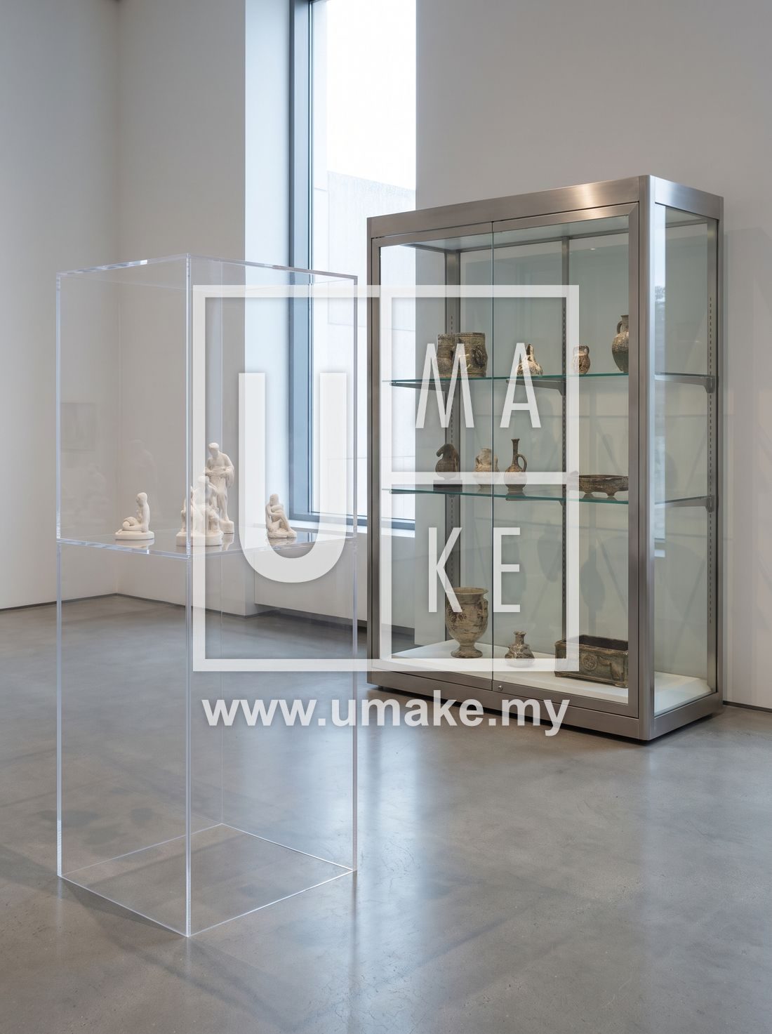 A clear acrylic display case beside a glass display case