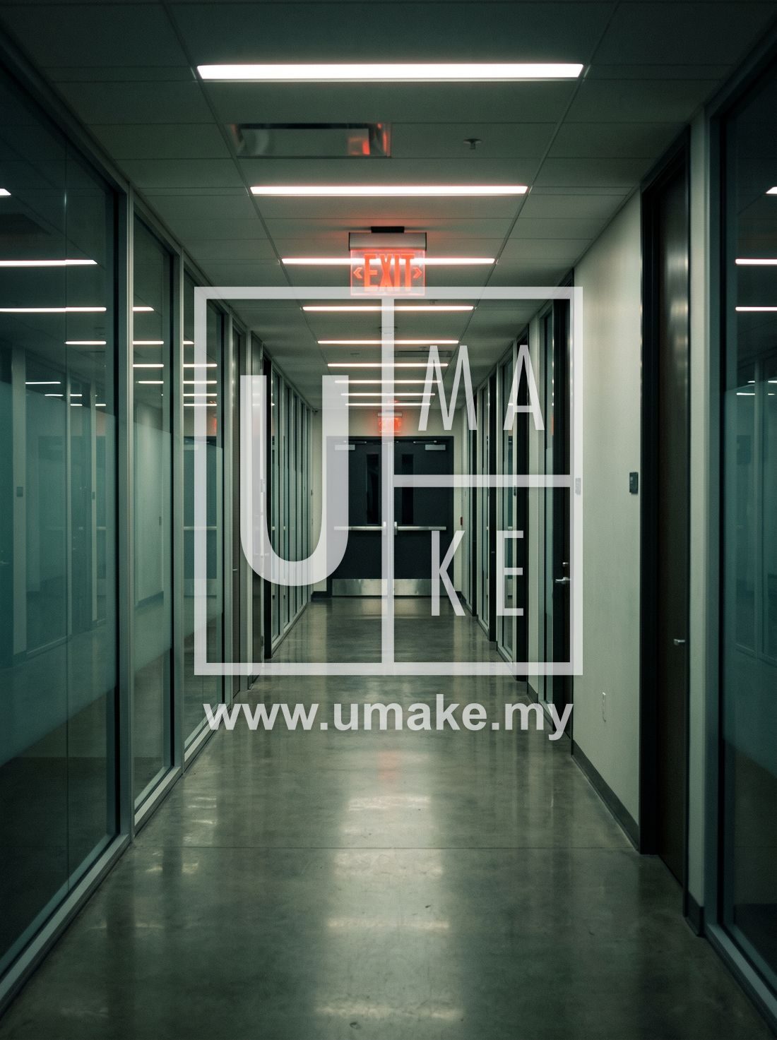 An office building corridor with an illuminated exit sign
