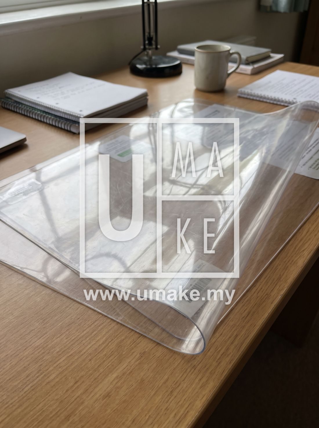 A transparent plastic table protector on a study desk