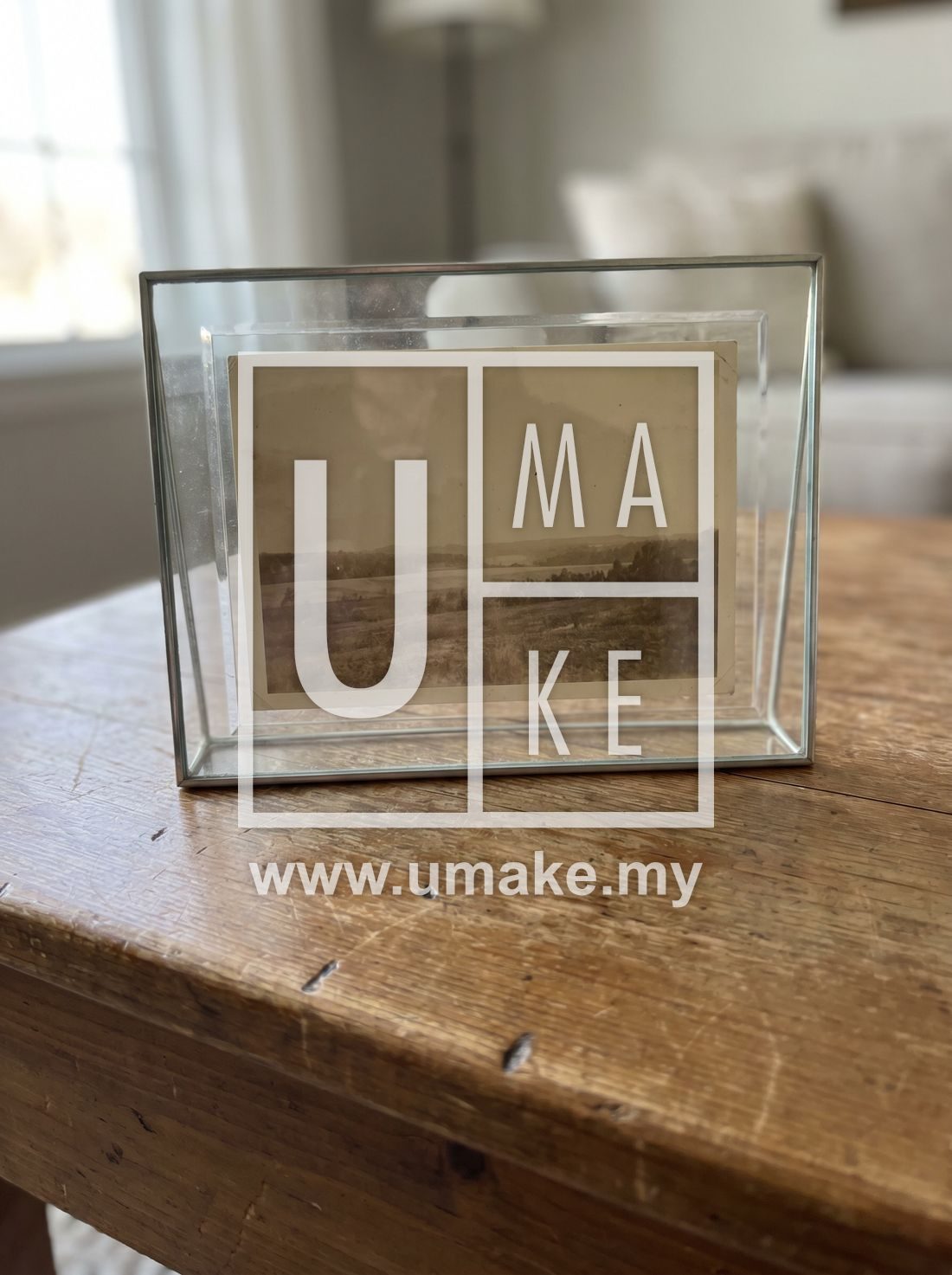 A glass photo frame on a wooden table