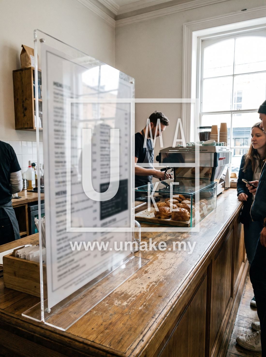 A cafe counter with a clear acrylic menu display