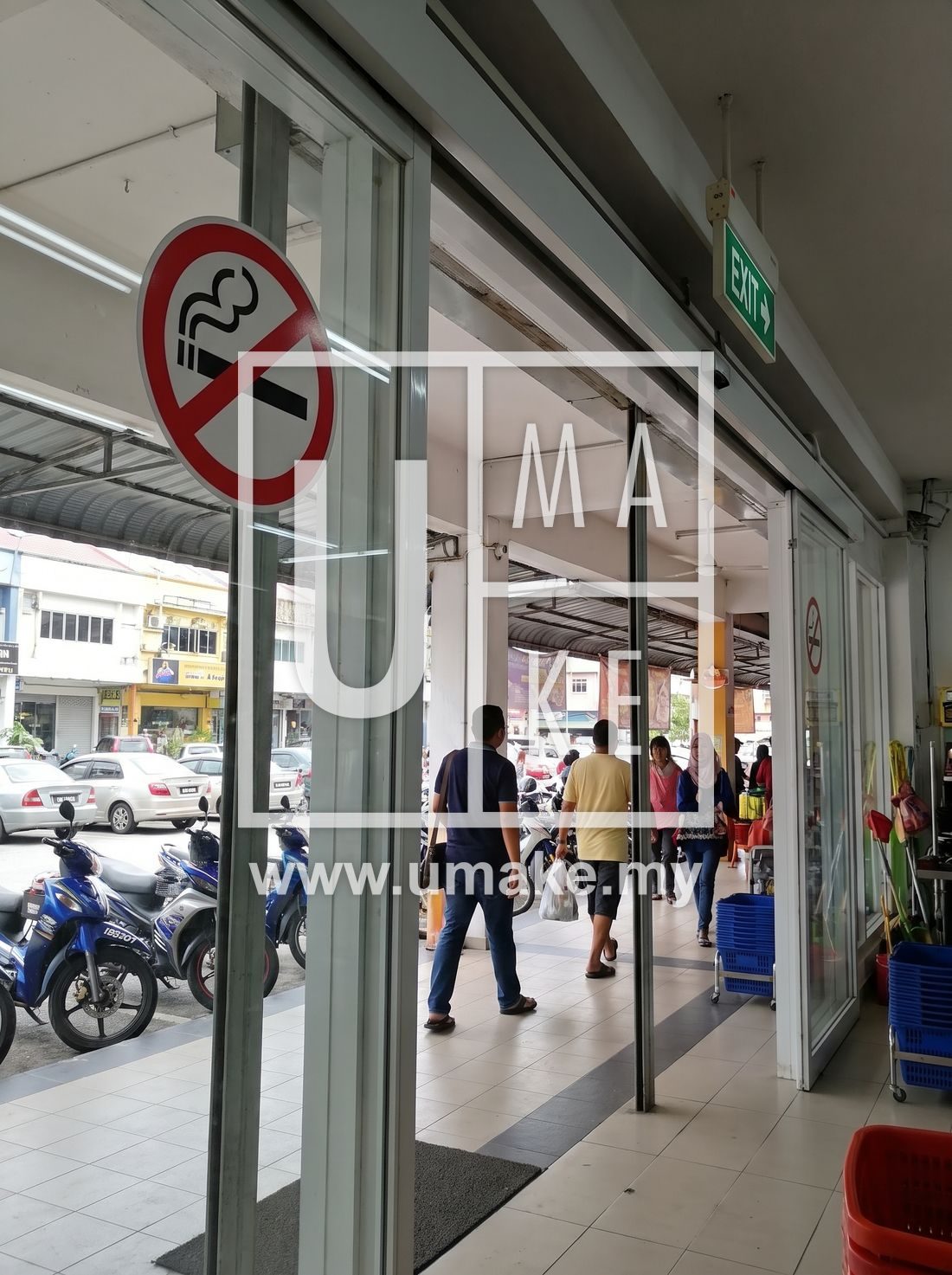 Retail shop entrance with a no smoking sign and an exit sign