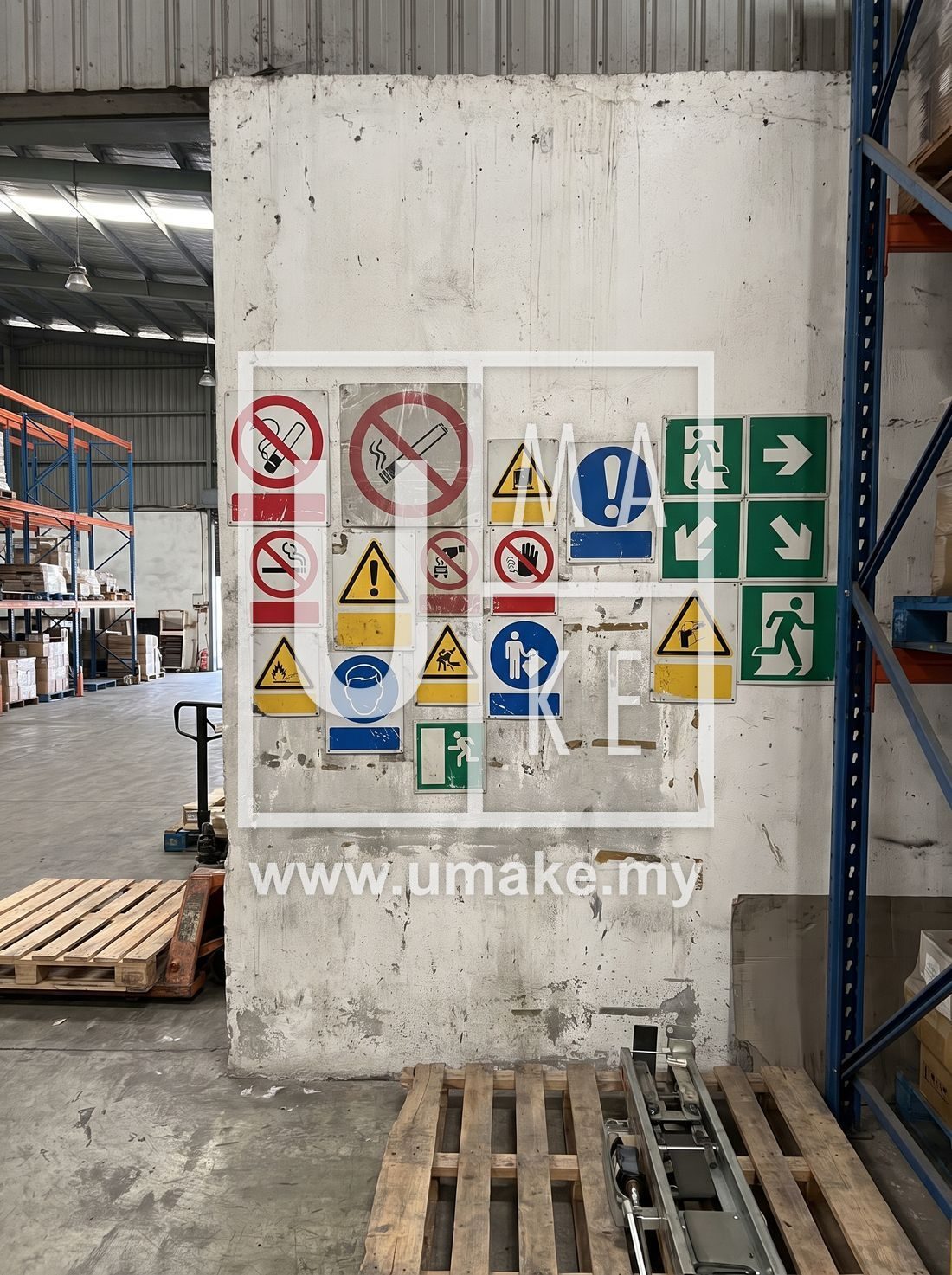 Wall of mounted safety signage inside a Malaysian warehouse